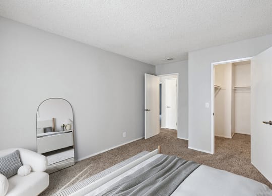 Model Bedroom with Carpet and Walk In Closet at Bridges on Sunset Apartments in Suisun City, CA.