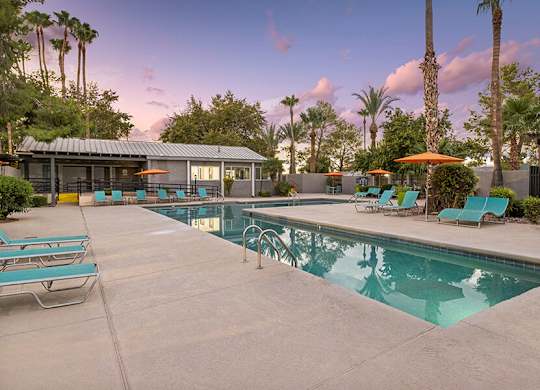 Community Swimming Pool with Pool Furniture at Lakeside Casitas Apartments located in Tucson, AZ.