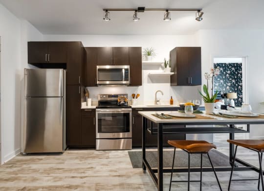 Model kitchen with stainless steel appliances and a counter top