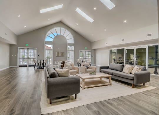 a living room filled with furniture and a large window