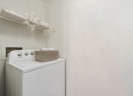 Model Laundry Room with Wood-Style Flooring at The Commons at Haynes Farm Apartments in Boston, MA.