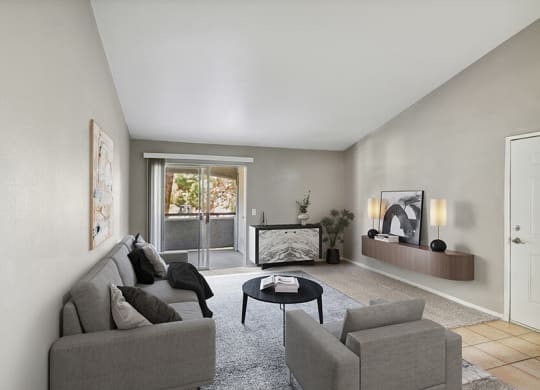 Model Living Room with Carpet and Patio Accessibility at Verraso Apartments in Las Vegas, NV.