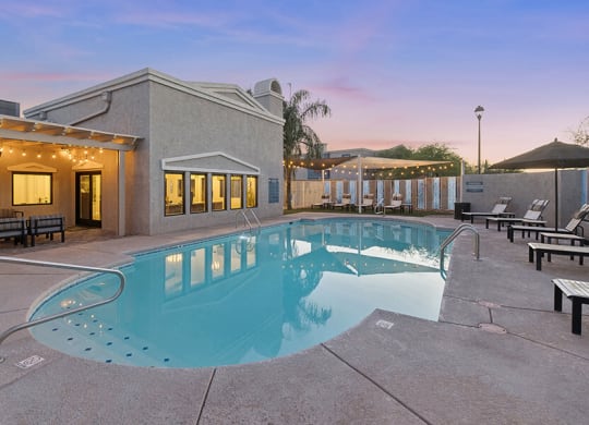 Community Swimming Pool with Pool Furniture at Ridgeline Apartments in Tucson, AZ.