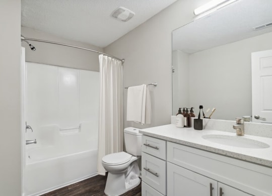 Model bathroom with tub and shower at Retreat at Stonecrest Apartments