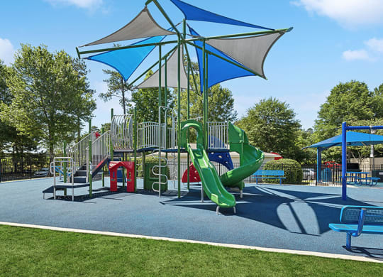 Community Playground with Slides and a Canopy at Retreat at Stonecrest Apartments located in Lithonia, GA.