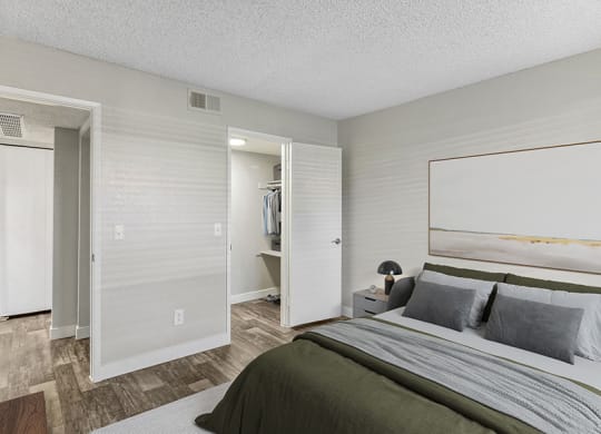 Model Bedroom with Wood-Style Flooring and Walk In Closet at Meadow Ridge Apartments in Las Vegas, NV.