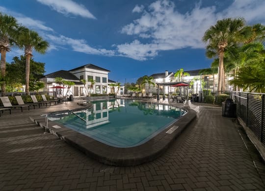Community Swimming Pool with Pool Furniture at Rosehill Preserve Apartments located in Orlando, FL.