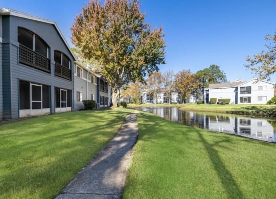 Clubhouse rear patio and community grounds with walking path