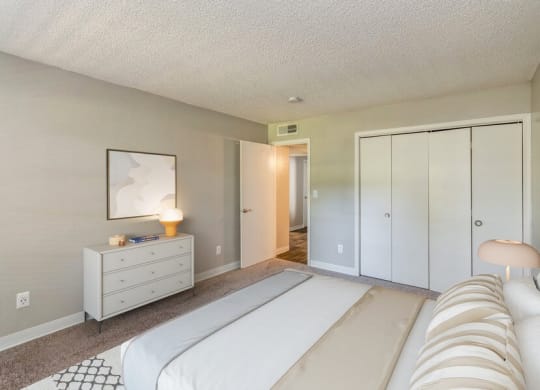 Model Bedroom with Carpet and Closet at Indigo Park Apartments in Albuquerque, NM.
