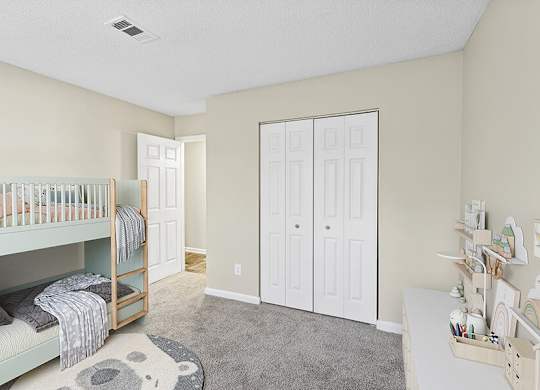 Model Bedroom with Carpet and Closet at Element 41 Apartments located in Marietta, GA.
