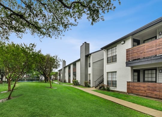 Apartment building exterior showcasing private patios
