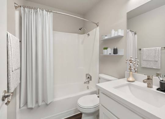 Model Bathroom with White Cabinets, Wood-Style Flooring & Shower/Tub at Walnut Creek Apartments located in Walnut Creek, CA.