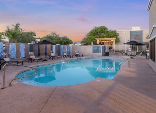 Community Swimming Pool with Pool Furniture at Ridgeline Apartments in Tucson, AZ.