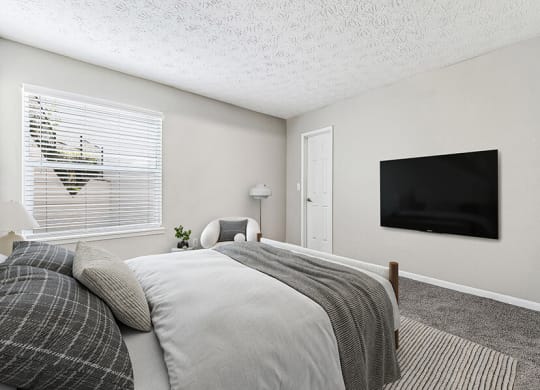 Model Bedroom with Carpet and Window View at Paramont Apartments in Duluth, GA.