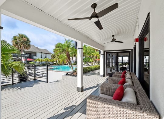 Outdoor Covered Patio with Furniture at Rosehill Preserve Apartments in Orlando, FL.