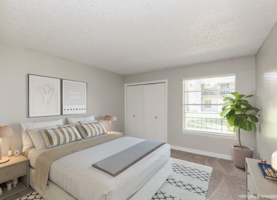 Model Bedroom with Carpet and Window View at Indigo Park Apartments in Albuquerque, NM.