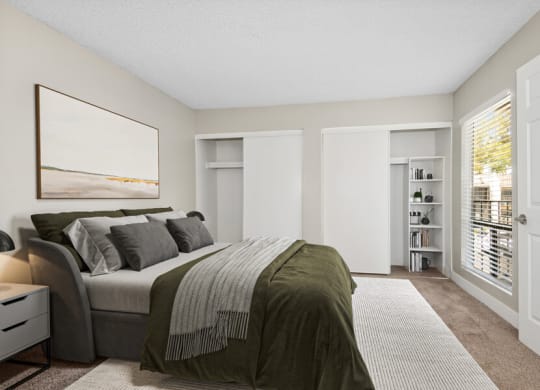 Model apartment bedroom with a large bed and a large window at Villages at Metro Center, Arizona