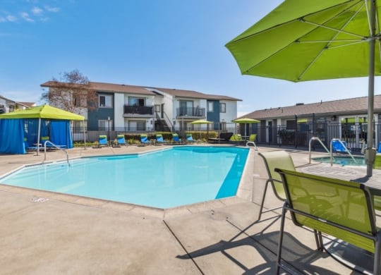 Swimming pool and pool deck with loungers and tables