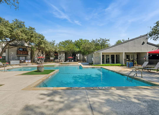 Community Swimming Pool with Pool Furniture at Summit Ridge Apartments located in Arlington, TX.