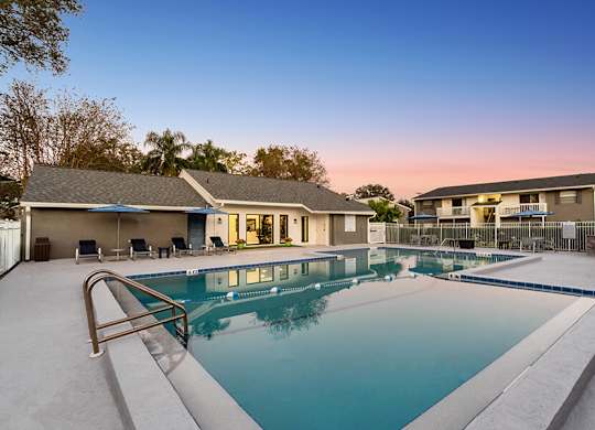 Community Swimming Pool with Pool Furniture at Arbors at Orange Park Apartments located in Orange Park, FL.