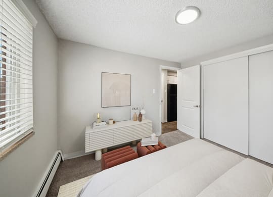 Model Bedroom with Carpet and Closet at Esprit at Cherry Creek Apartments in Glendale, CO.