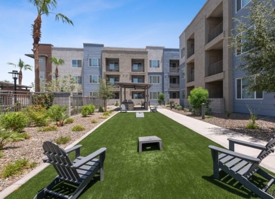 Outdoor game area with cornhole