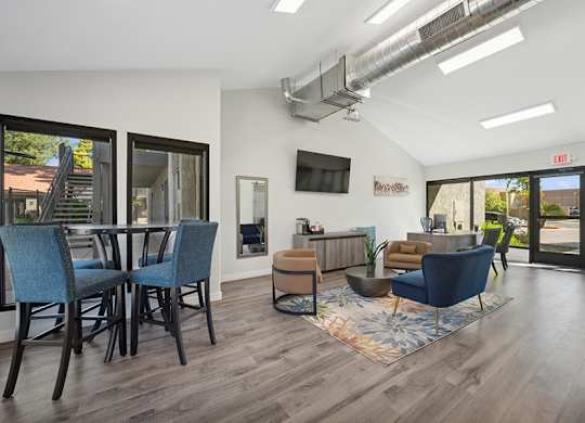 A modern living room with a blue chair and a brown ottoman.