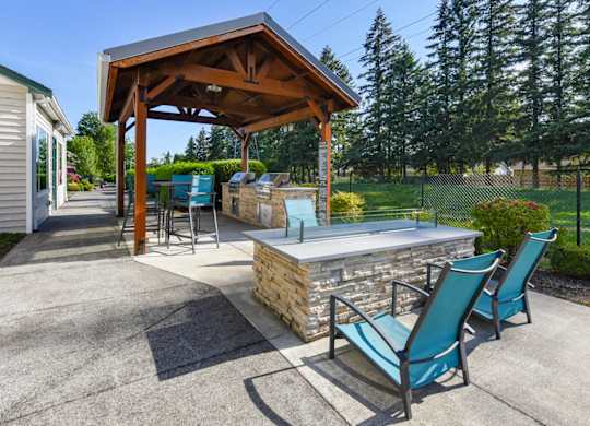 Outdoor Fire Pit & BBQ Area at Landings at Morrison Apartments located in Gresham, OR.