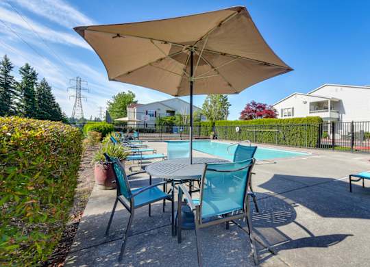 Community Swimming Pool with Pool Furniture at Landings at Morrison Apartments located in Gresham, OR.