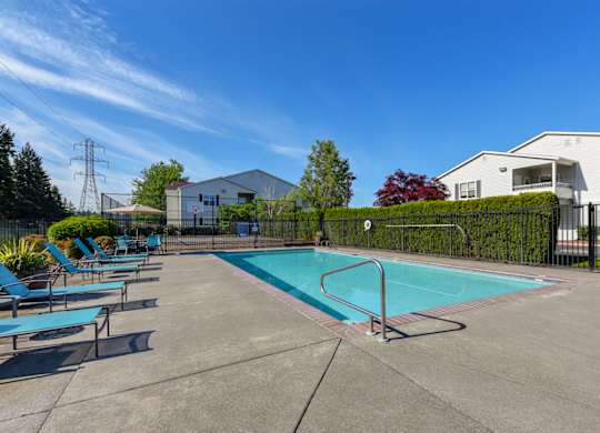 Community Swimming Pool with Pool Furniture at Landings at Morrison Apartments located in Gresham, OR.