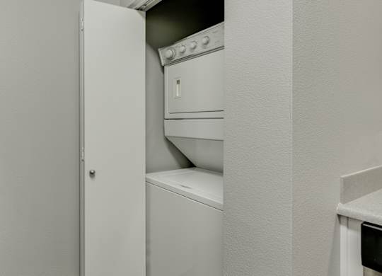 Model Laundry Room with Washer & Dryer at Landings at Morrison Apartments located in Gresham, OR.
