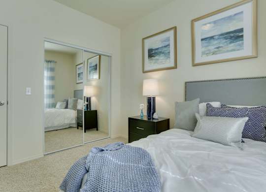 Model Bedroom with Carpet and Closet at Landings at Morrison Apartments located in Gresham, OR.