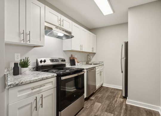 Model kitchen with white cabinets and stainless steel appliances