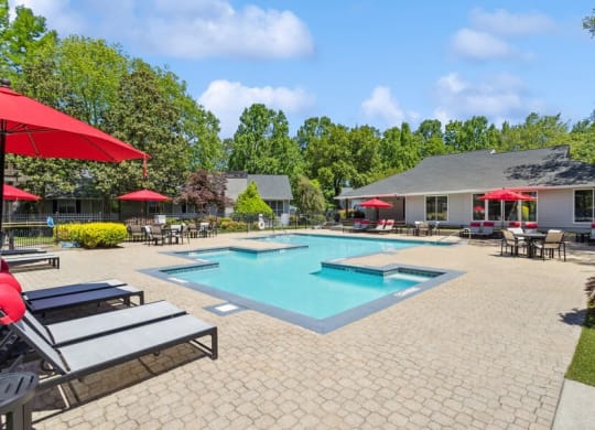 Community Swimming Pool with Pool Furniture at Dunwoody Village Apartments in Atlanta, GA.