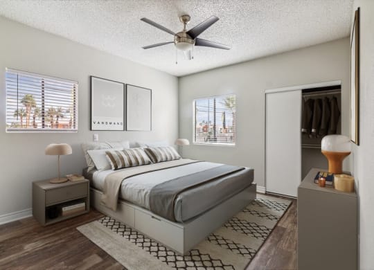 a bedroom with a bed and a ceiling fan