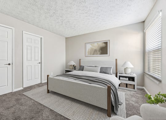 Model Bedroom with Carpet and Window View at Paramont Apartments in Duluth, GA.