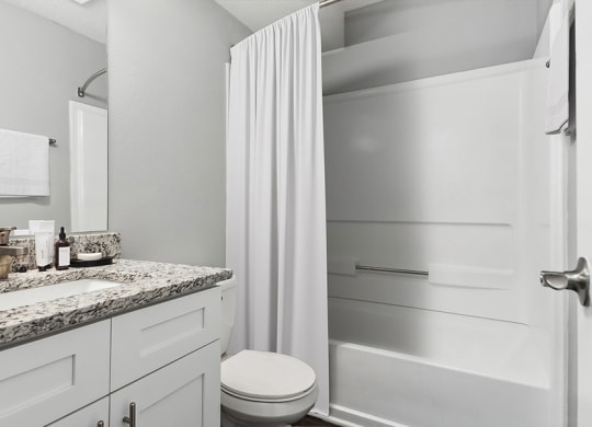 Model Bathroom with Wood-Style Flooring and Shower/Tub at Stoney Trace Apartments in Charlotte, NC.