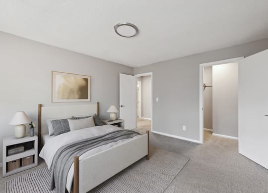 Model Bedroom with Carpet and Walk In Closet at Spring Forest Apartments in Raleigh, NC.