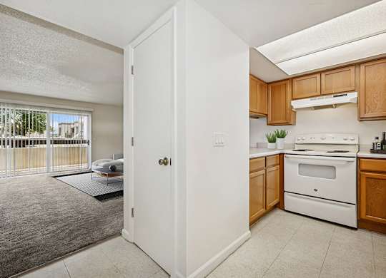 Model Classic Kitchen with Tile Flooring and View of Living Room at Butler Ridge Apartments located in Glendale, AZ.