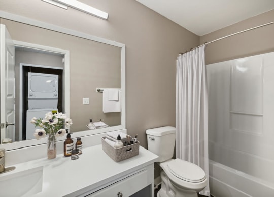 Model bathroom with white vanity at Vue at Baymeadows Apartments in Jacksonville, Florida