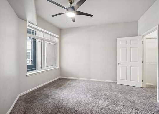Model Bedroom with Carpet and Walk-In Closet at Altitude on Fifth Apartments located in Salt Lake City, UT.