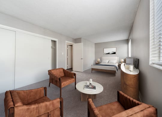 Model Living Room with Carpet, Double Closets and Window View at Bridges at 9 Mile Station Apartments in Denver, CO.