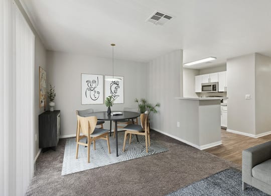 Model Dining Room and Kitchen Area with View of Living Room at Loma Vista Apartments in Las Vegas, NV.