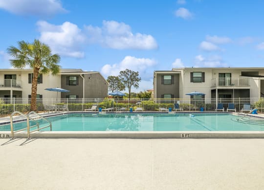 Swimming pool with apartment buildings in the background