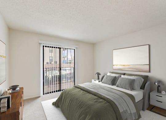 Model Bedroom with Carpet and Patio Accessibility at Grandstand Apartments in Marietta, GA.