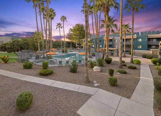 Community Swimming Pool with Pool Furniture at Tanque Verde Apartments located in Tucson, AZ.