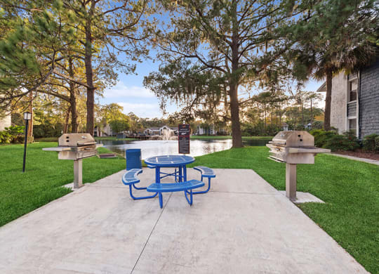 Outdoor BBQ Area with Furniture at Vue at Baymeadows Apartments in Jacksonville, FL.