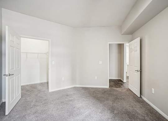 Model Bedroom with Carpet and Walk-In Closet at Altitude on Fifth Apartments located in Salt Lake City, UT.