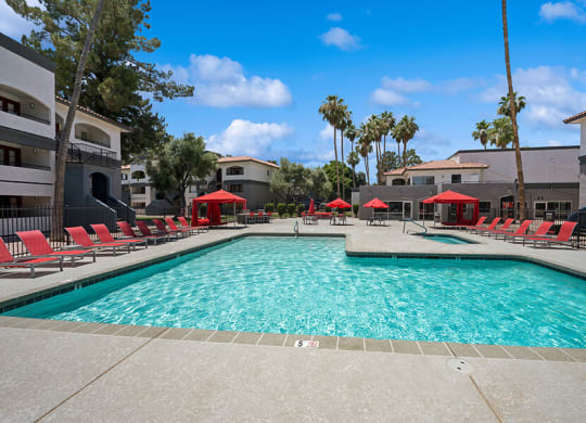 Community Swimming Pool with Pool Furniture at Country Club Verandas Apartments located in Mesa, AZ.