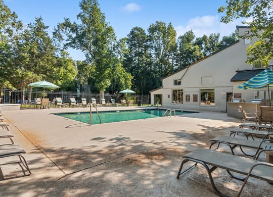 Community Swimming Pool with Pool Furniture at Stoney Trace Apartments in Charlotte, NC.